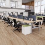 An open office space featuring multiple desks and chairs arranged for collaborative work.